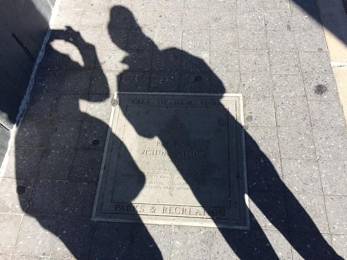 Long shadows across the visitor center beside Poe Park and the cottage