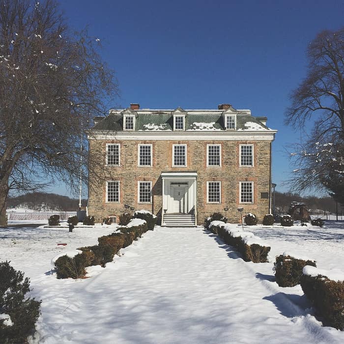 Front view of the Van Cortlandt House with its gateposts and entrance